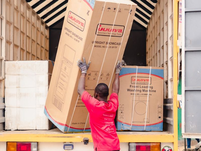 Boxed appliance being loaded onto a truck